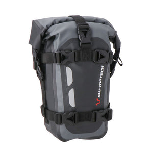 A black and gray SW MOTECH Drybag with reflective details and straps for attachment to a motorcycle.