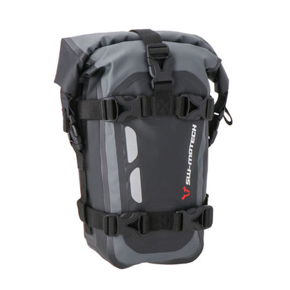 A black and gray SW MOTECH Drybag with reflective details and straps for attachment to a motorcycle.