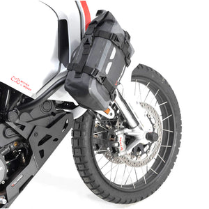 Black motorcycle pannier bag attached to a white motorcycle.