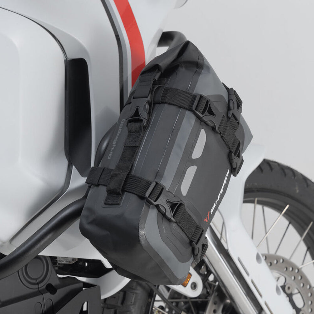 Black motorcycle saddlebag attached to a white motorcycle.